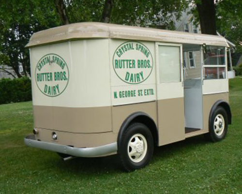 A right rear view of the truck showing the rear corner of the body built into the doors and hinged on the side of the body.