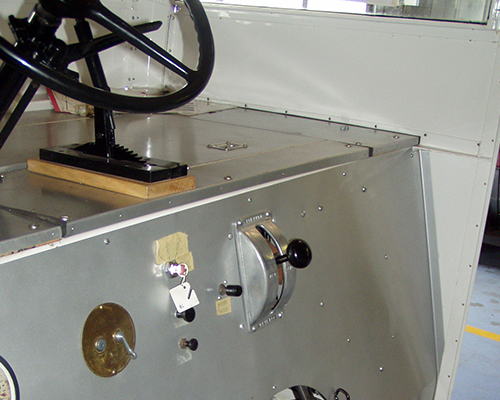 The rear of the generator that is mounted on the engine flywheel extending into the driver's compartment.